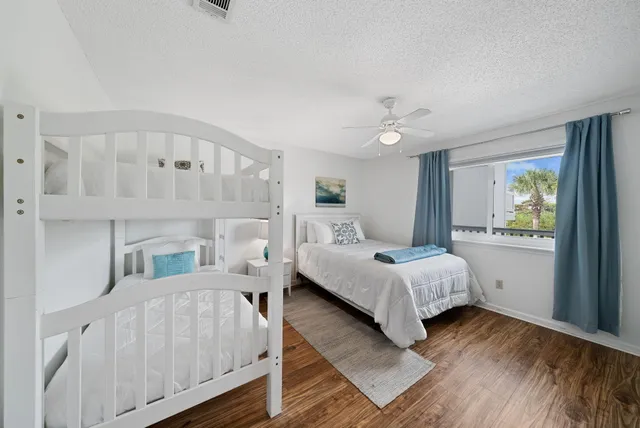 a bedroom with a bed mirror and window