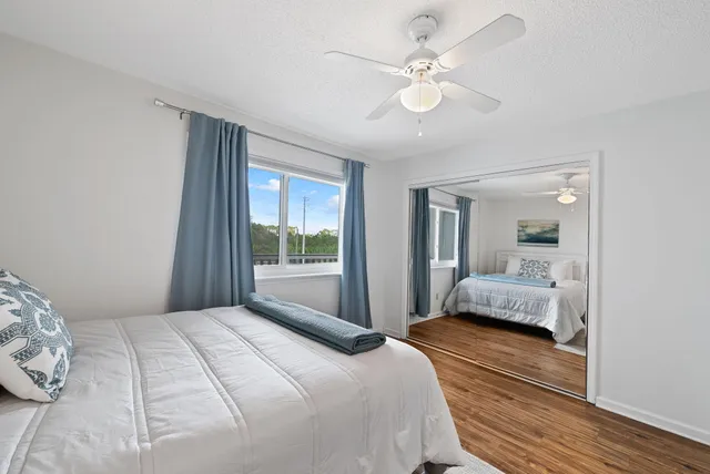 a bedroom with a large bed and a large window