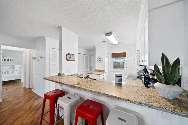 a kitchen with sink and view of living room