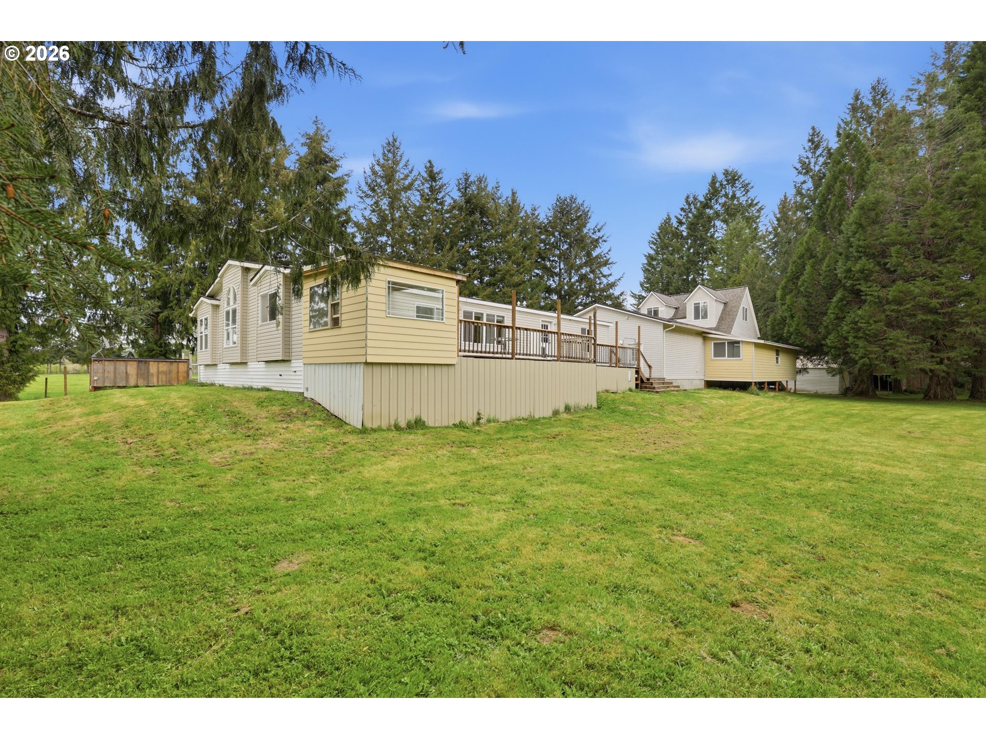 82320 Bay Road Seaside, OR 97138 - Photo 35 of 47 a white house that has a big yard with wooden fence