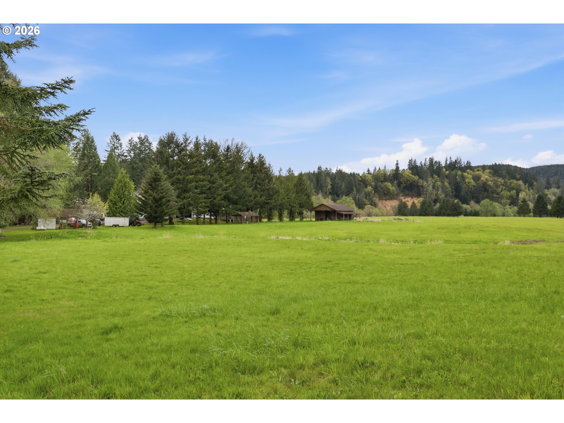 82320 Bay Road Seaside, OR 97138 - Photo 45 of 47 a view of a green field with trees in the background