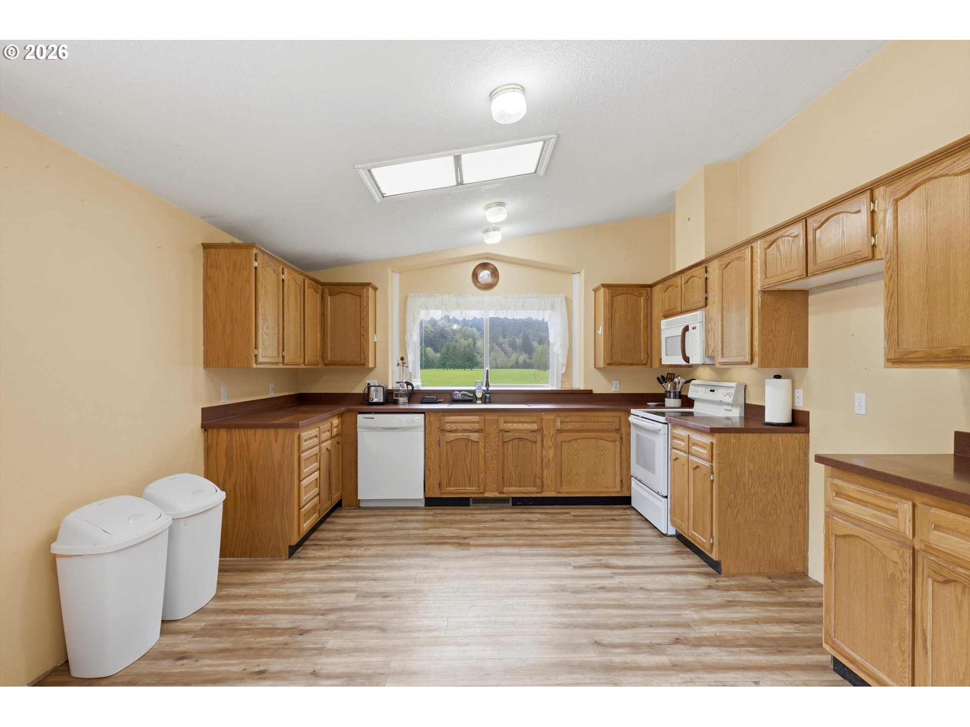 82320 Bay Road Seaside, OR 97138 - Photo 5 of 47 a large kitchen with a wooden floor and a large window