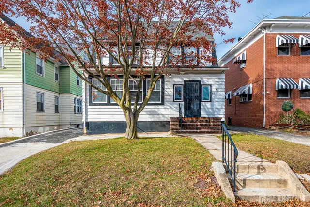 a house that has a tree in front of it