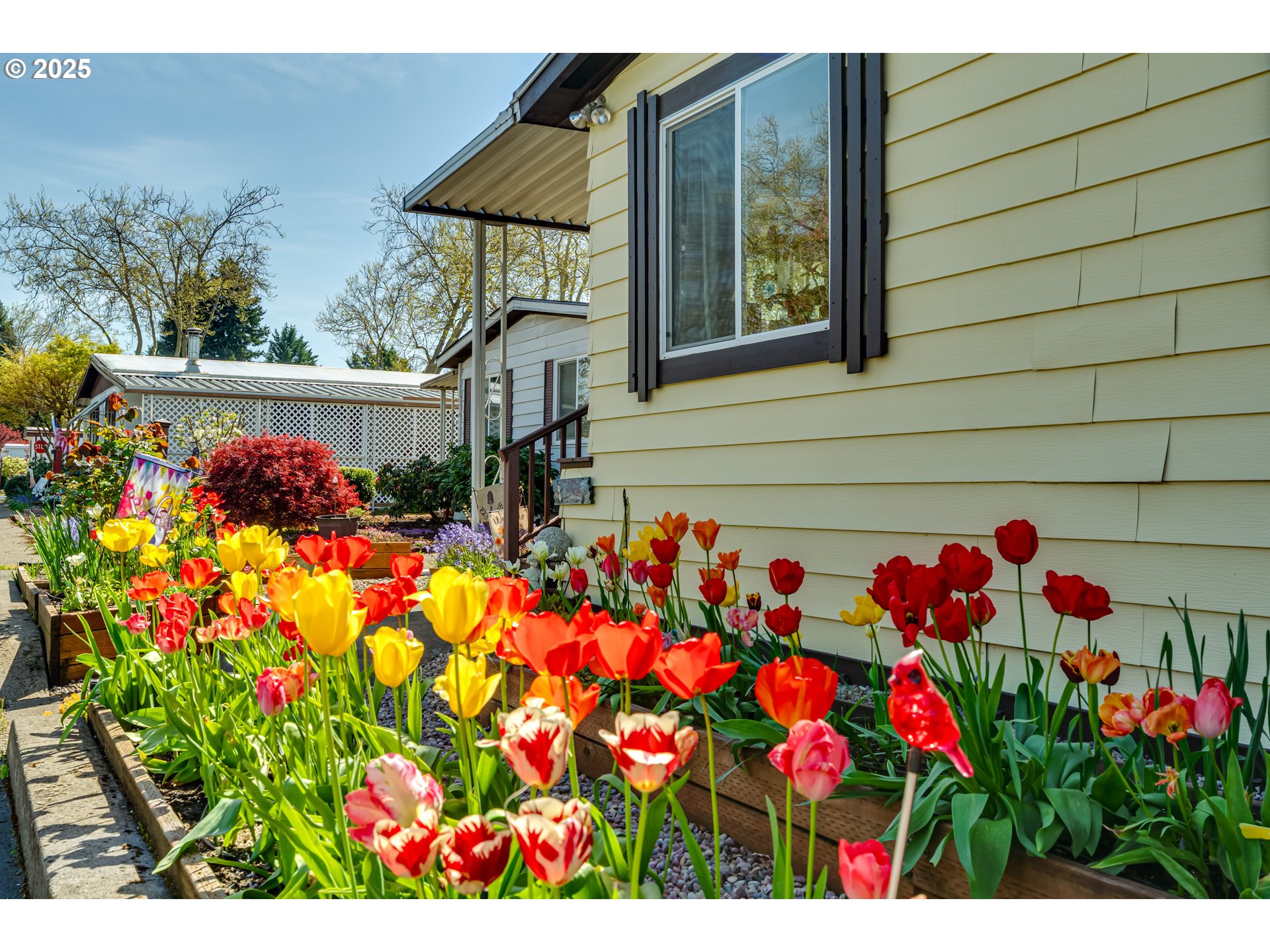 1400 Candlelight Drive, Unit 177 Eugene, OR 97402 - Photo 3 of 32 a view of a house with a flower garden
