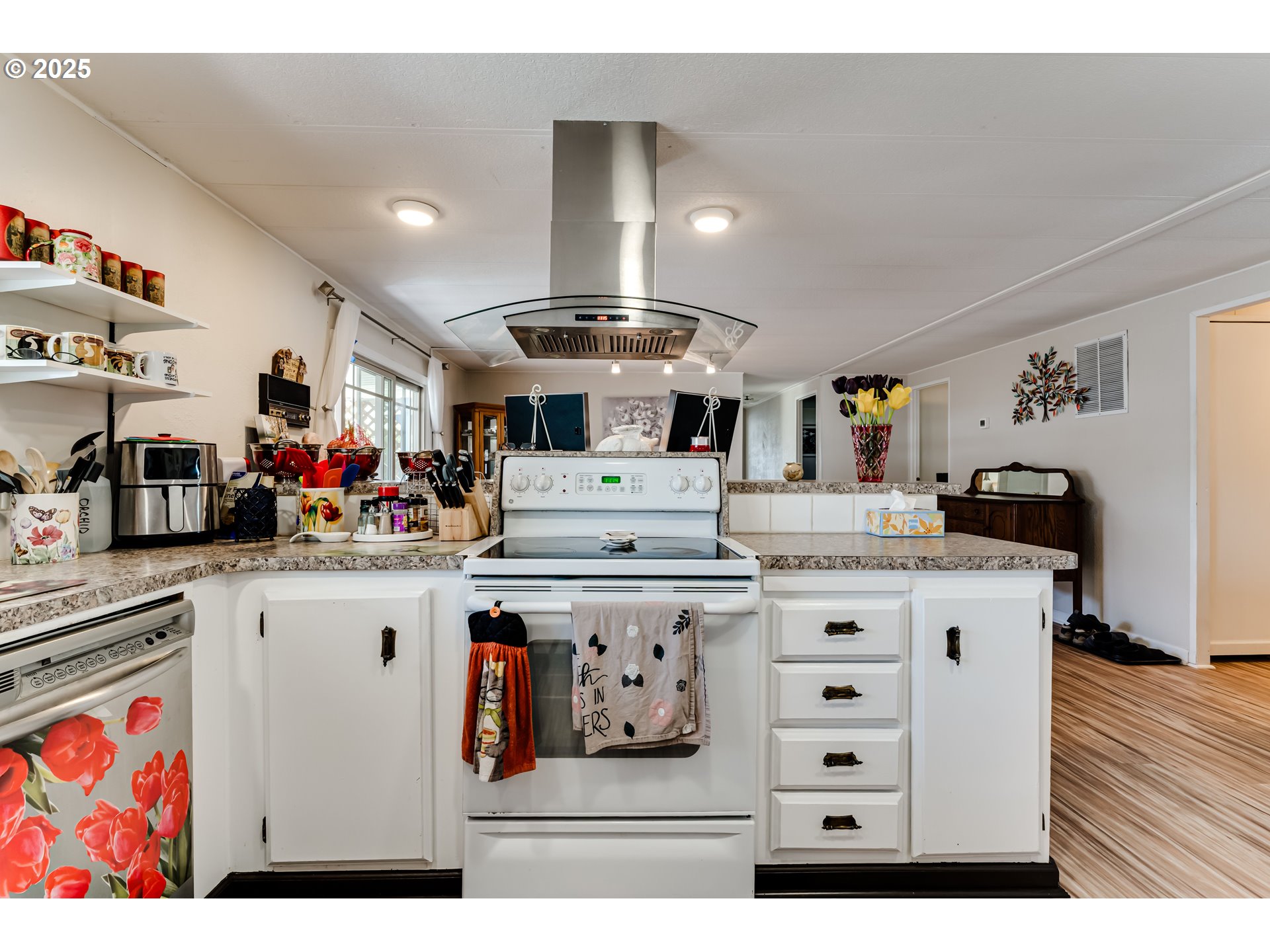 1400 Candlelight Drive, Unit 177 Eugene, OR 97402 - Photo 10 of 32 a living room with kitchen island granite countertop furniture and a flat screen tv