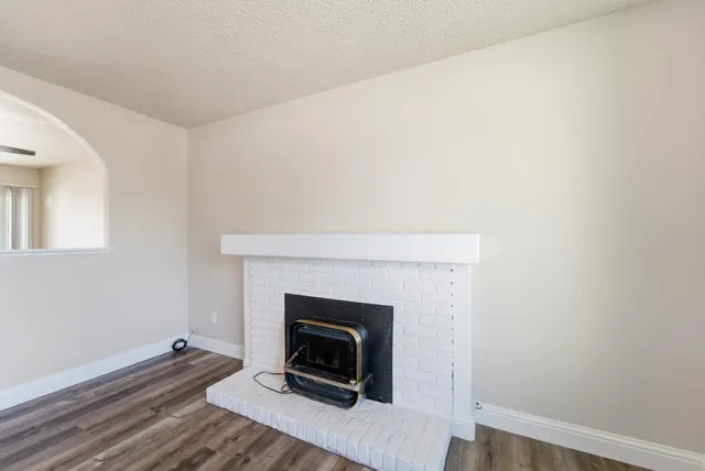 a living room with a fireplace and a wooden floor