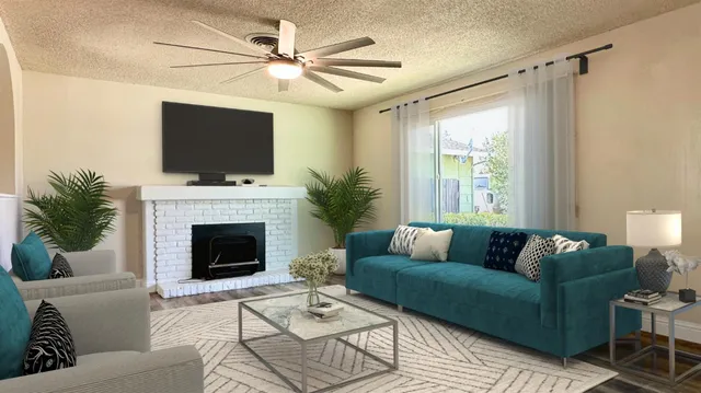 a living room with furniture a flat screen tv and a fireplace