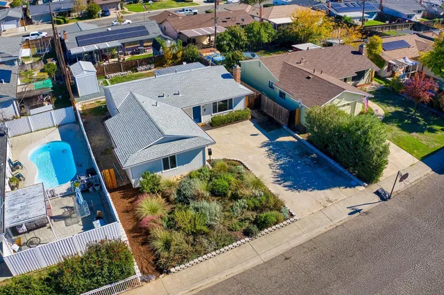 an aerial view of residential houses with outdoor space