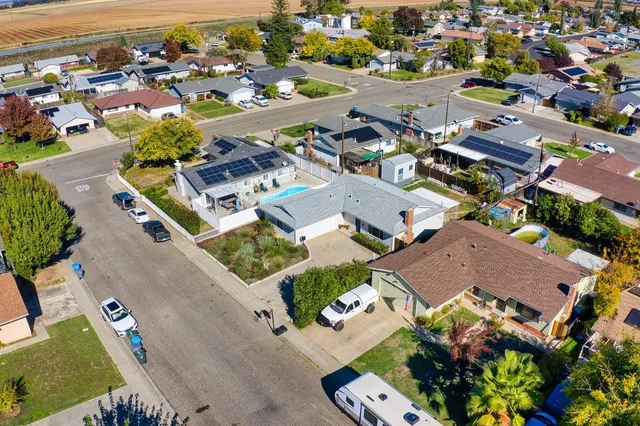 an aerial view of residential houses with outdoor space
