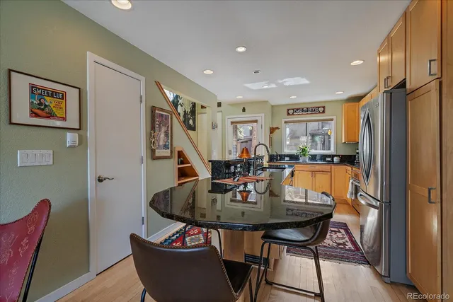 a view of a dining room with furniture and a potted plant