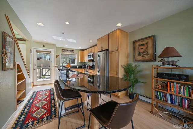 a dining room with furniture and a book shelf