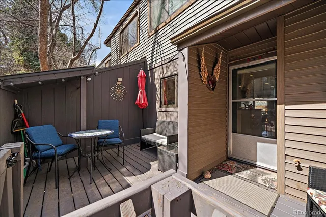 a view of a chairs and table in the back of the house