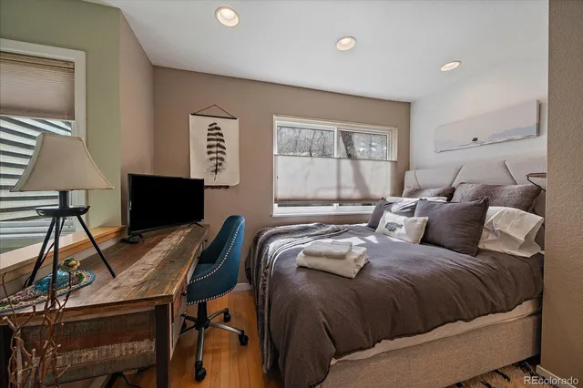 a bedroom with a bed and a mirror