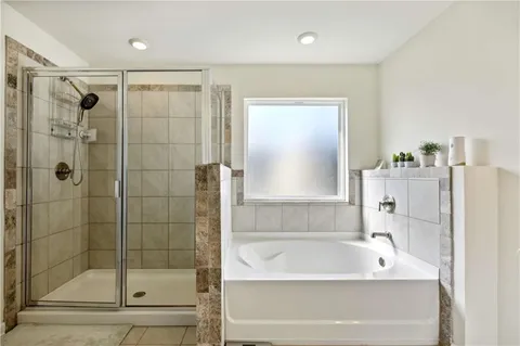 a bathroom with a bathtub and a shower