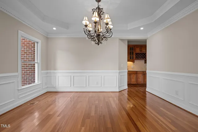 a view of empty room with wooden floor fireplace and stairs