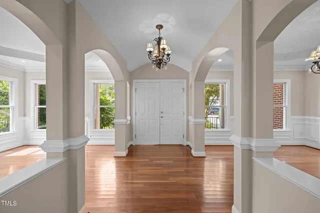 a kitchen with stainless steel appliances granite countertop wooden floors and wide window