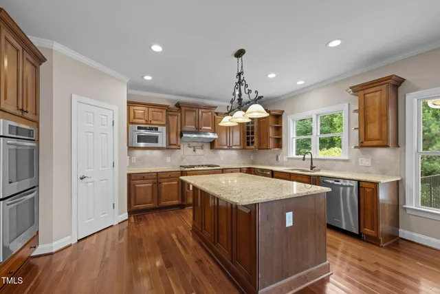 an empty room with windows and ceiling fan