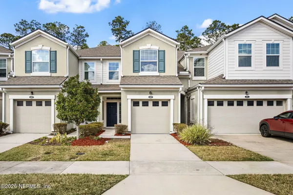 a front view of a house with a yard and garage