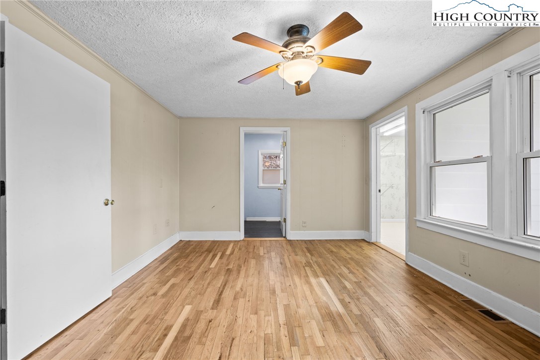 336 Willowdale Church Road Vilas, NC 28692 - Photo 12 of 45 wooden floor in an empty room with a window
