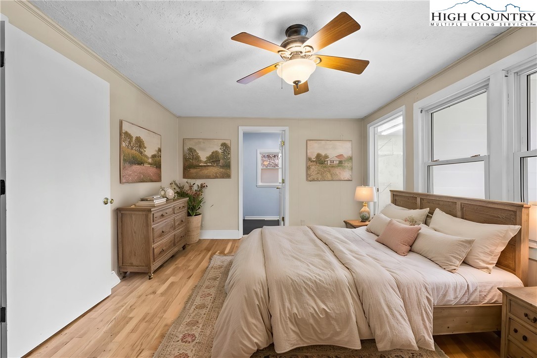 336 Willowdale Church Road Vilas, NC 28692 - Photo 13 of 45 a spacious bedroom with a large bed and a chandelier