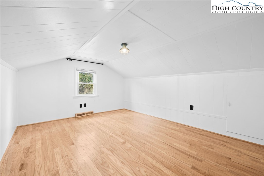 336 Willowdale Church Road Vilas, NC 28692 - Photo 23 of 45 a view of an empty room with wooden floor and a window