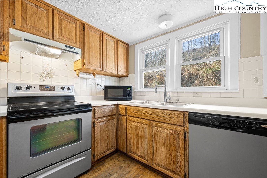 336 Willowdale Church Road Vilas, NC 28692 - Photo 28 of 45 a kitchen with granite countertop a sink stainless steel appliances and window
