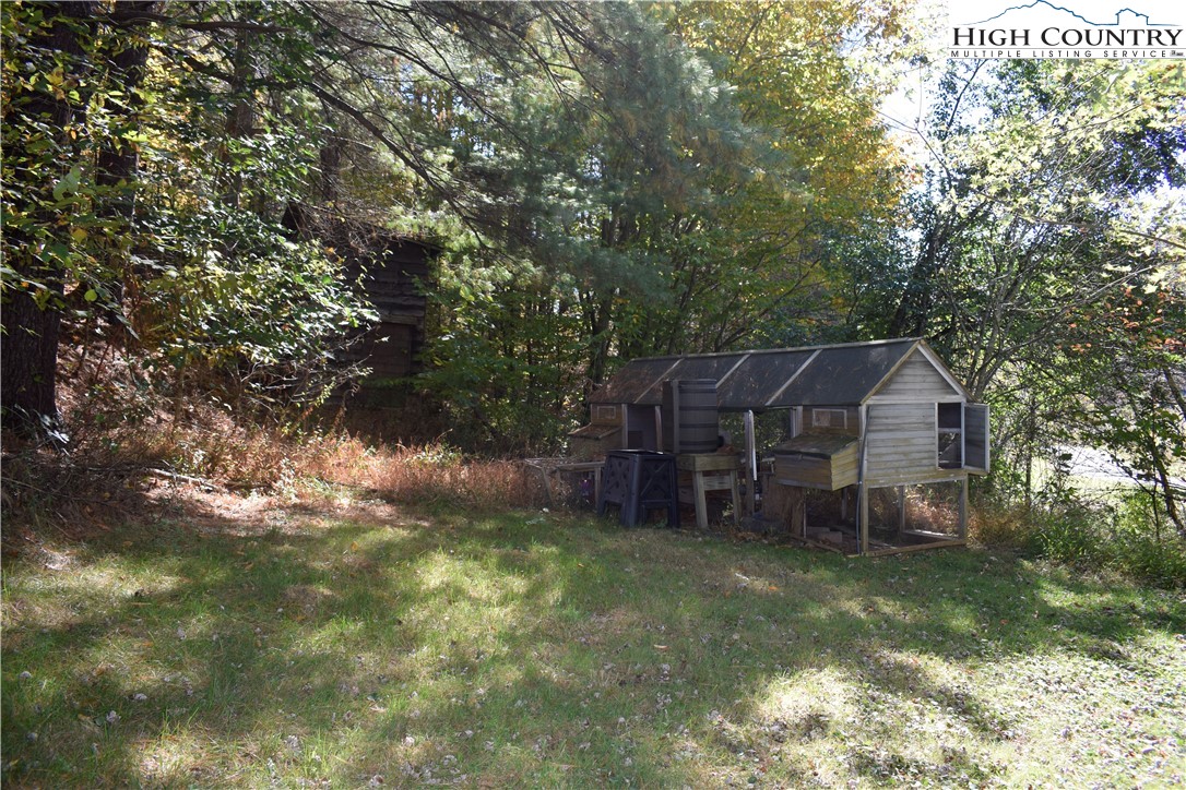 336 Willowdale Church Road Vilas, NC 28692 - Photo 42 of 45 a view of a house with a yard and a tree
