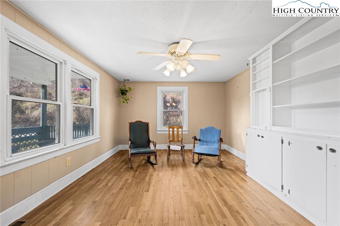 336 Willowdale Church Road Vilas, NC 28692 - Photo 10 of 45 a workspace with furniture a chandelier and wooden floor