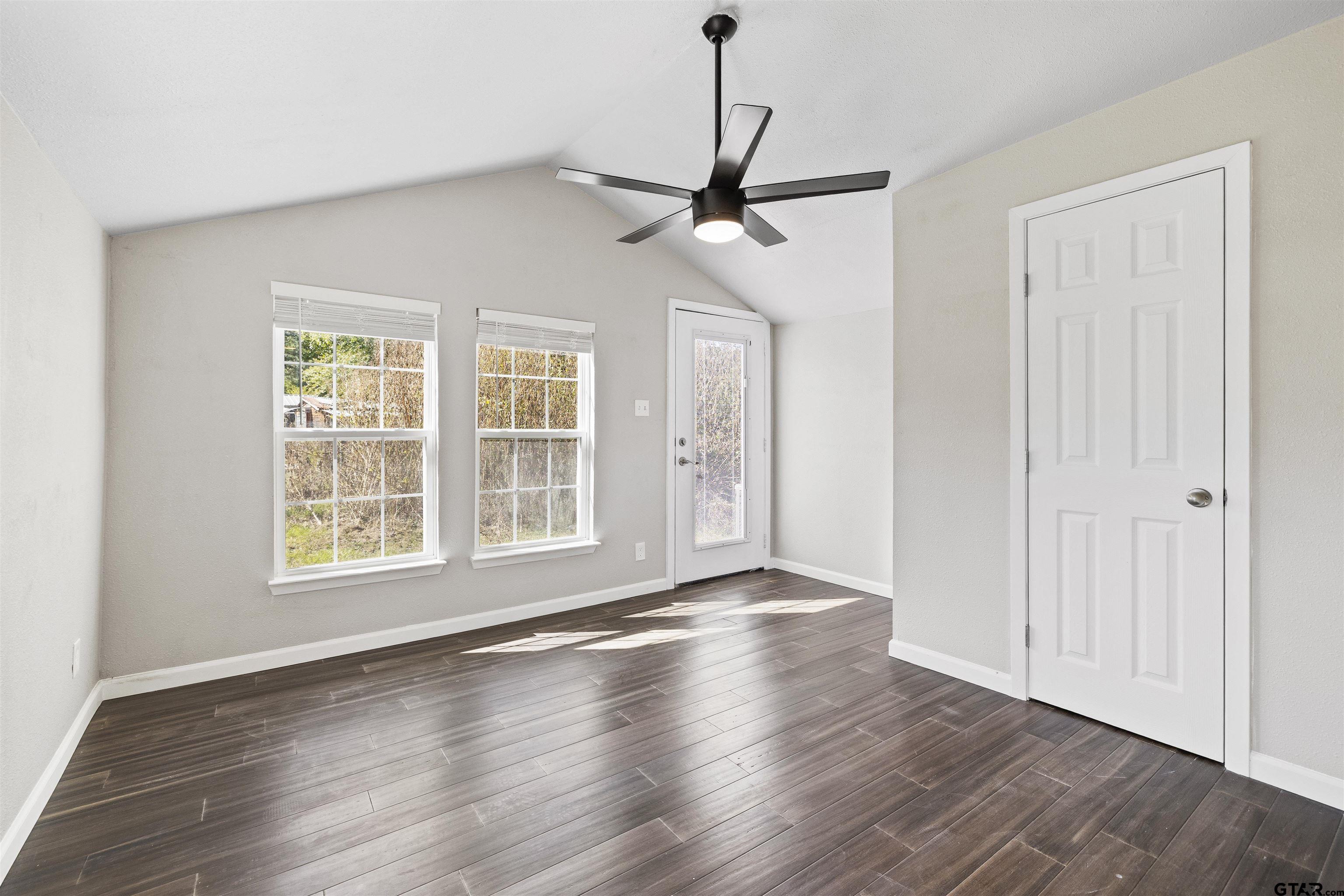 229 Orchard Street Alba, TX 75410 - Photo 11 of 16 a view of an empty room with wooden floor and a window