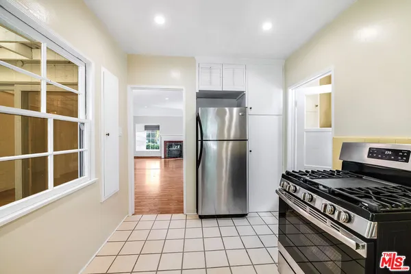 a kitchen with a refrigerator a stove and a sink