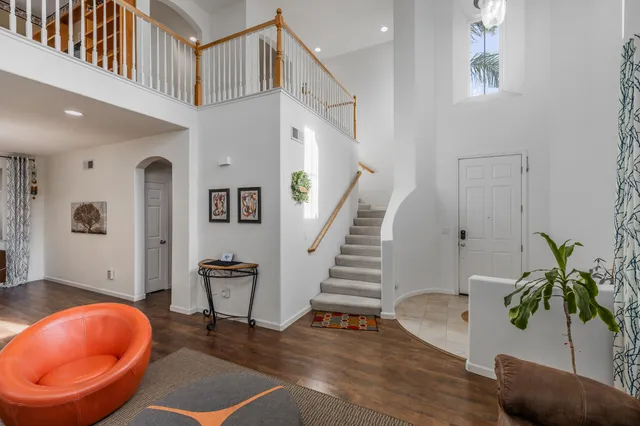 a view of entryway and hall with wooden floor