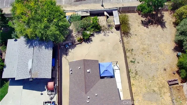 an aerial view of a house with a yard