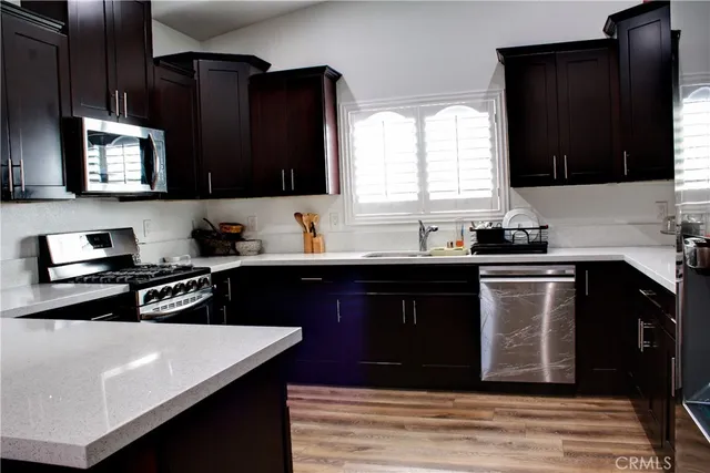 a kitchen with a sink dishwasher a stove and a refrigerator
