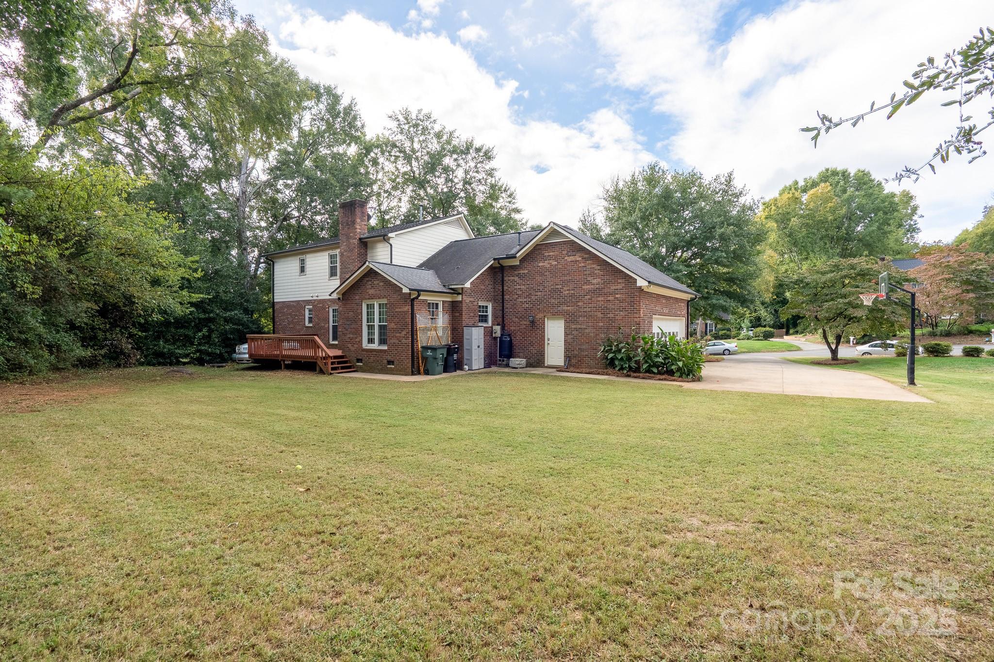 5820 Wingate Way Northwest Concord, NC 28027 - Photo 14 of 14 a front view of a house with a garden and tree