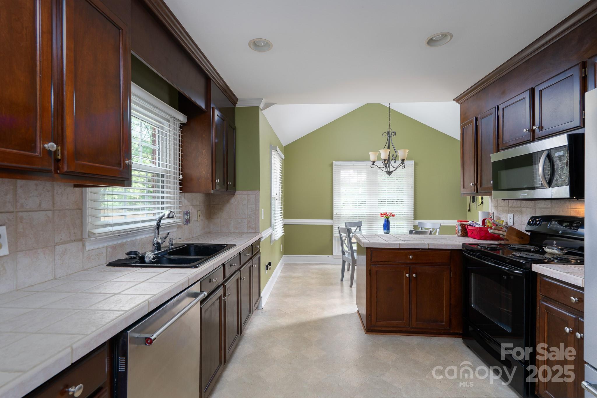 5820 Wingate Way Northwest Concord, NC 28027 - Photo 2 of 14 a kitchen with a sink stove and cabinets