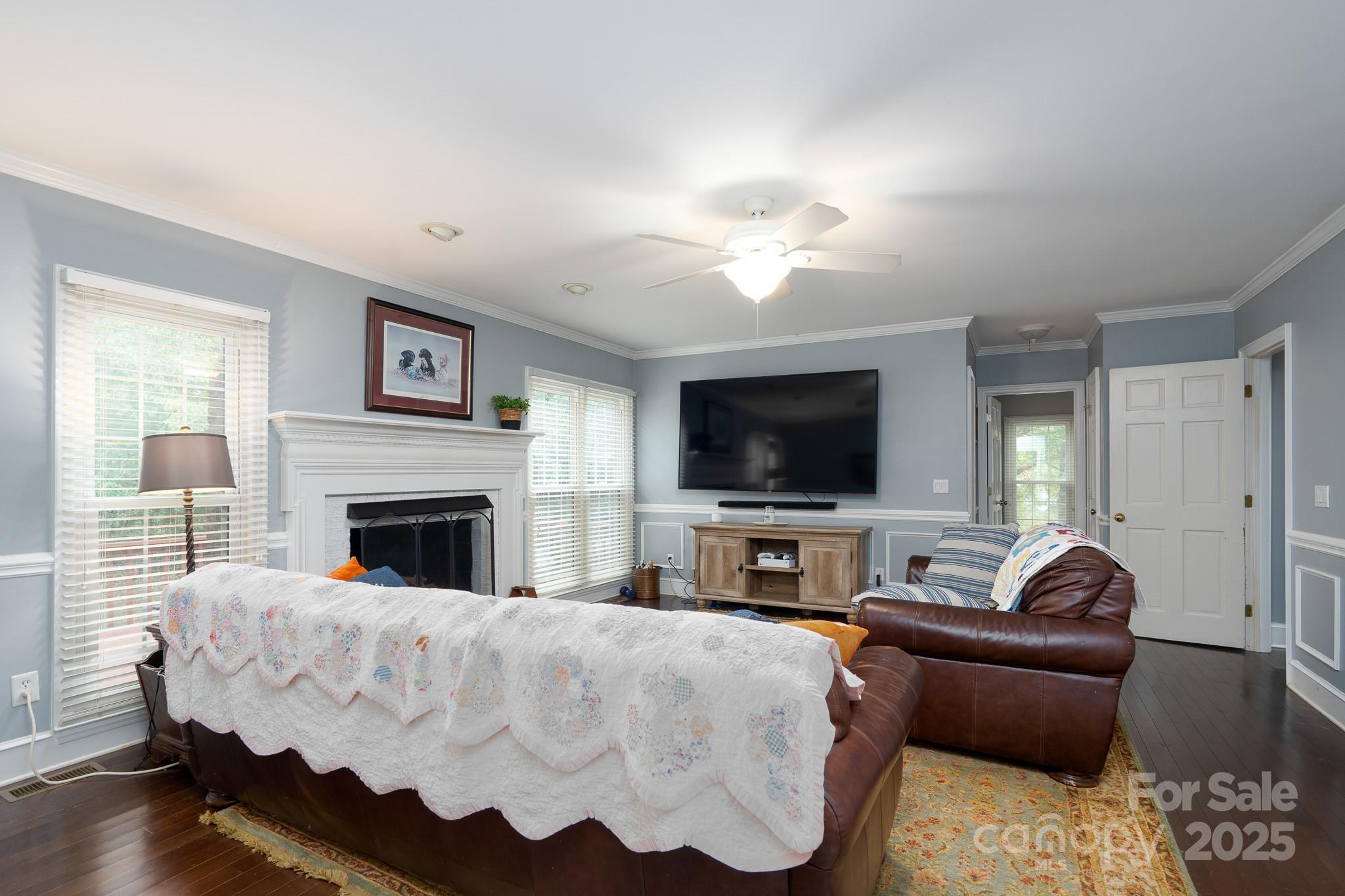 5820 Wingate Way Northwest Concord, NC 28027 - Photo 3 of 14 a living room with furniture and a flat screen tv