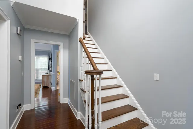 a view of a hallway with wooden floor and entryway