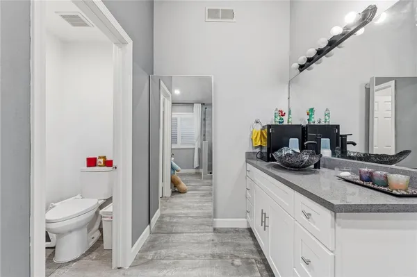 a bathroom with a shower sink and mirror
