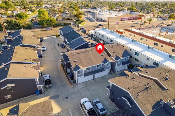 an aerial view of a house with a yard