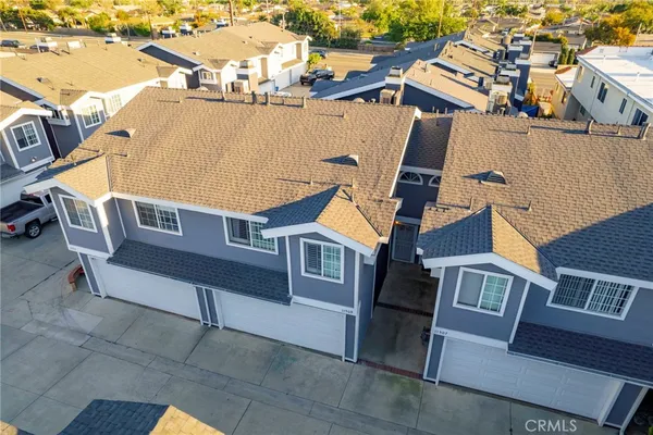 an aerial view of residential houses with outdoor space