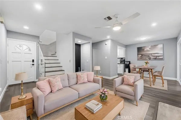 a living room with furniture and wooden floor
