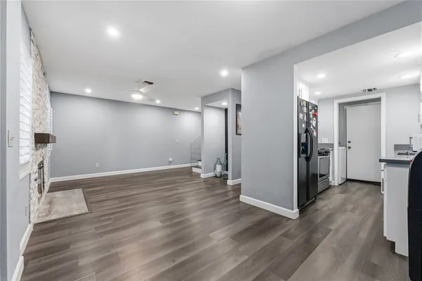 a view of empty room with wooden floor