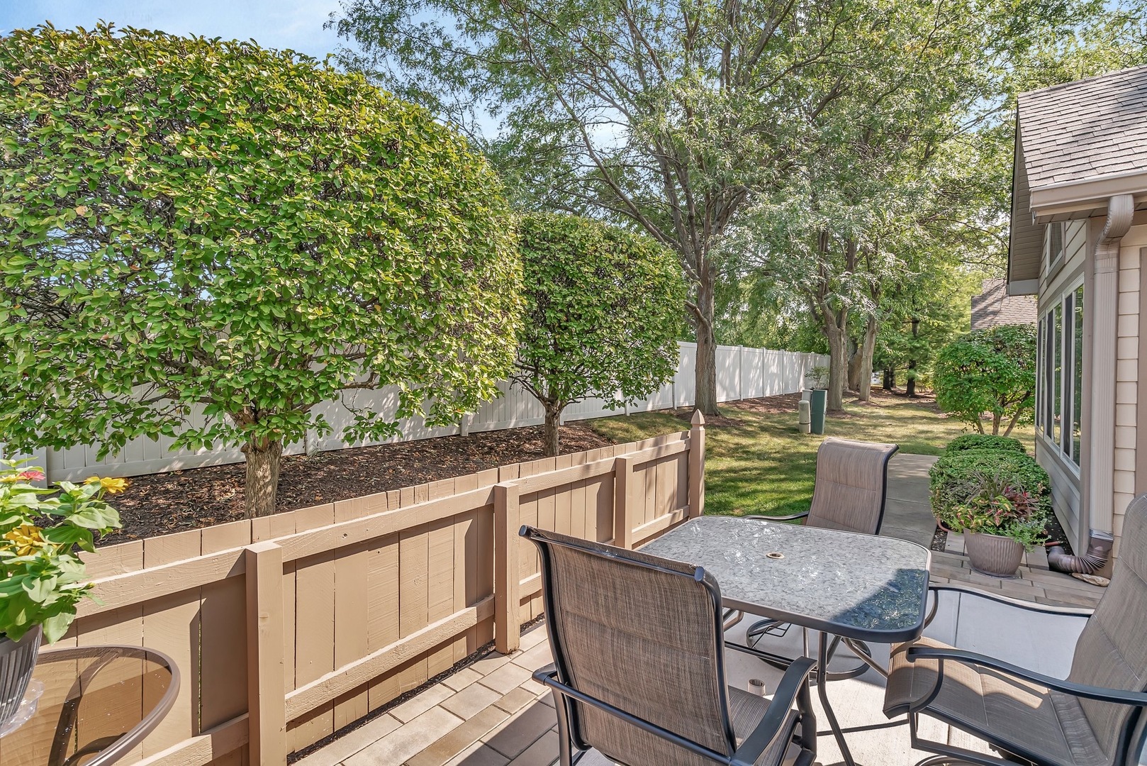 1950 Timbers Edge Circle Joliet, IL 60431 - Photo 23 of 24 a view of a patio with table and chairs with wooden floor and fence