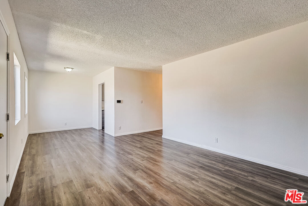 15815 South Haskins Avenue Compton, CA 90220 - Photo 16 of 29 a view of an empty room with wooden floor