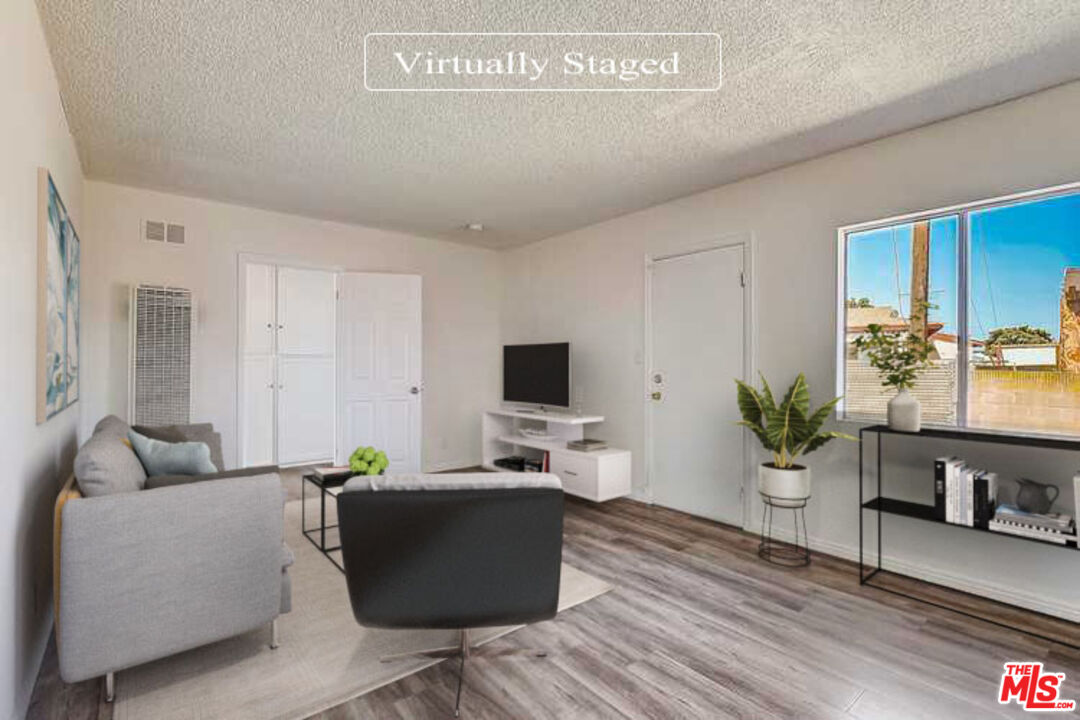 15815 South Haskins Avenue Compton, CA 90220 - Photo 2 of 29 a living room with furniture and a flat screen tv