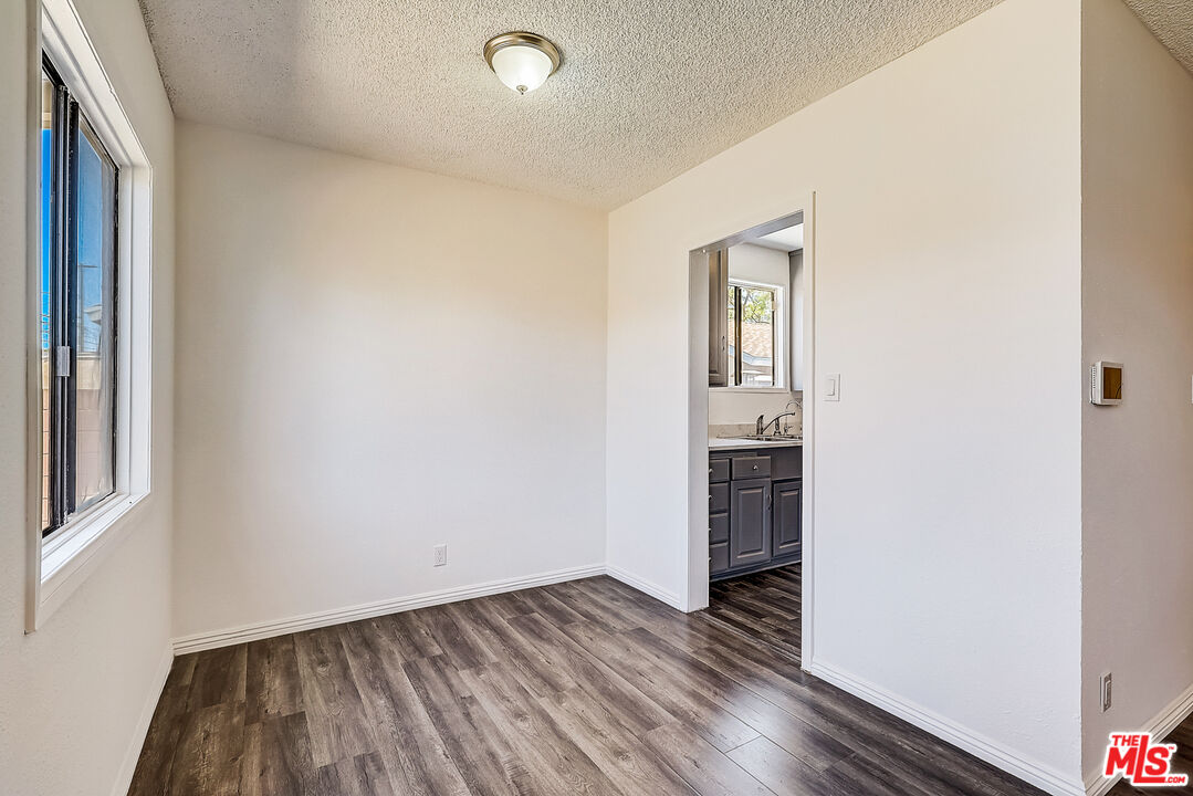 15815 South Haskins Avenue Compton, CA 90220 - Photo 5 of 29 an empty room with wooden floor and closet
