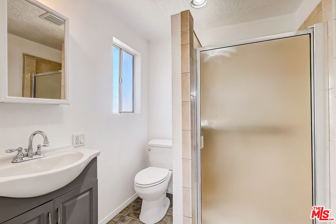 15815 South Haskins Avenue Compton, CA 90220 - Photo 8 of 29 a bathroom with a toilet a sink and a mirror