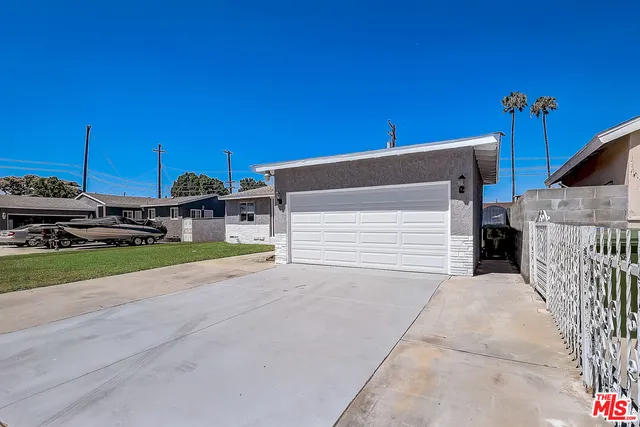 a view of a house with a road and a car parked