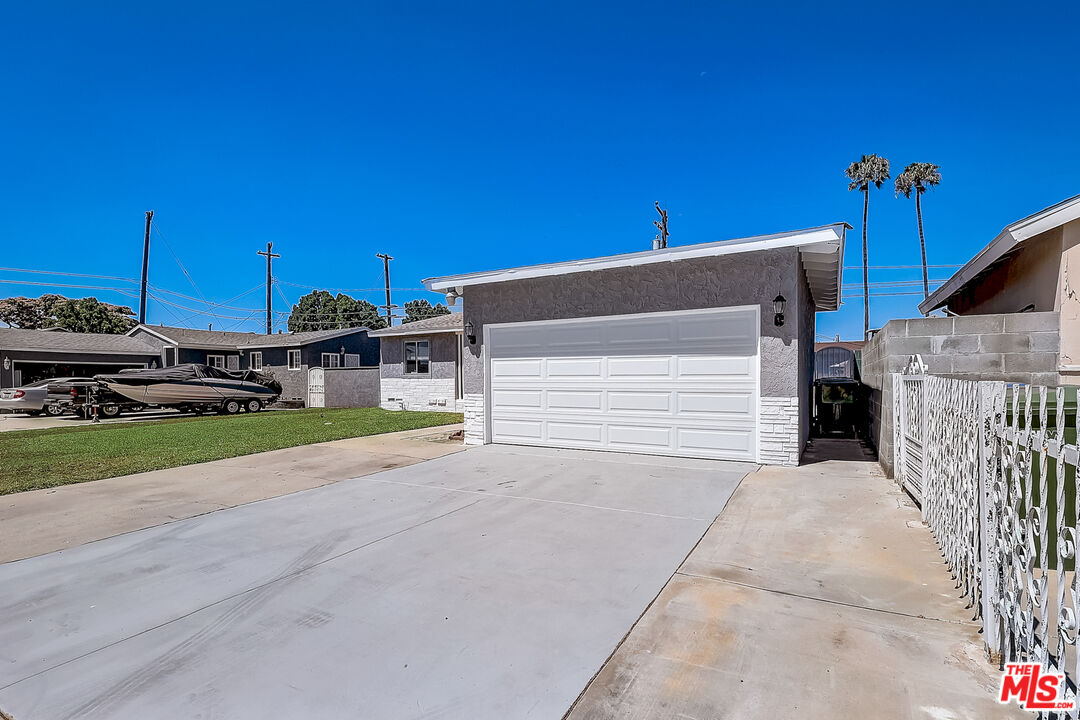 15815 South Haskins Avenue Compton, CA 90220 - Photo 10 of 29 a view of a house with a road and a car parked