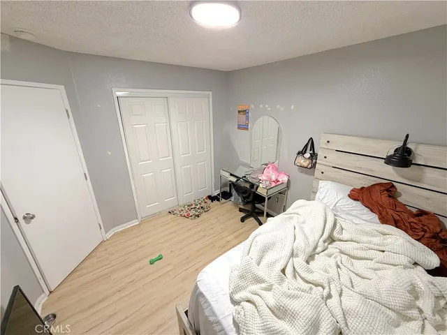 a bed room with a bed and a chair